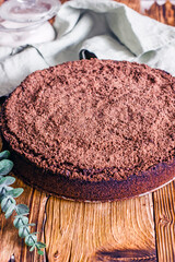 Homemade cake with chocolate chips on a wooden table, close-up
