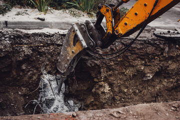 Old construction excavator digging a ditch or groove