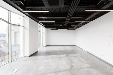 Interior photography, large spacious office center, with panoramic windows and unfurnished glass...