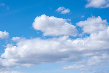 Fototapeta na wymiar Blue sky with white cumulus clouds. Perfect natural sky background for your photos