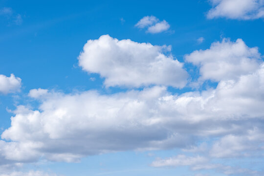 Blue sky with white cumulus clouds. Perfect natural sky background for your photos