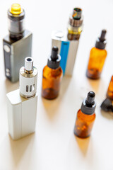 Vaping device e-cigarette electronic cigarette and liquid bottles isolated on white background....