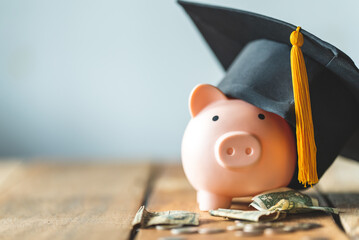 piggy bank With Graduation Cap on old wood,Money saving concept. - obrazy, fototapety, plakaty