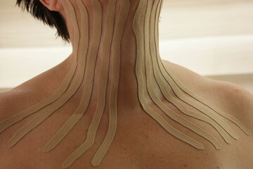 Kinesio tapes on female neck and chest.