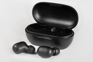Wireless bluetooth headset in black color. Box to store the headphones, also function as a battery...