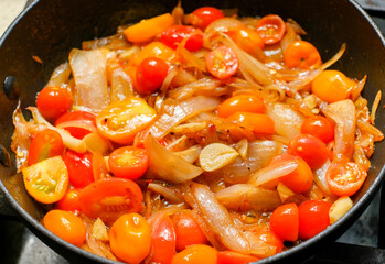 Red cherry tomatoes sauteed with onions shallot and garlic