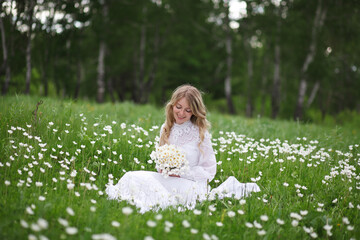 beautiful girl, a blonde in a vintage white dress walks in a blooming apple orchard, a bouquet of anemones, a bride