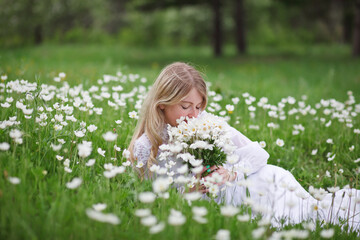 beautiful girl, a blonde in a vintage white dress walks in a blooming apple orchard, a bouquet of anemones, a bride