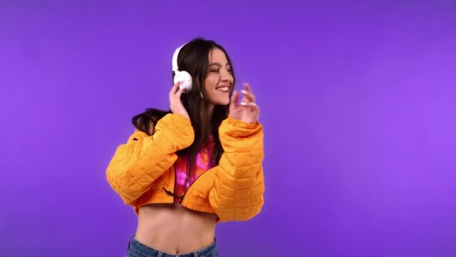 Smiling Dancer In Headphones Isolated On Purple