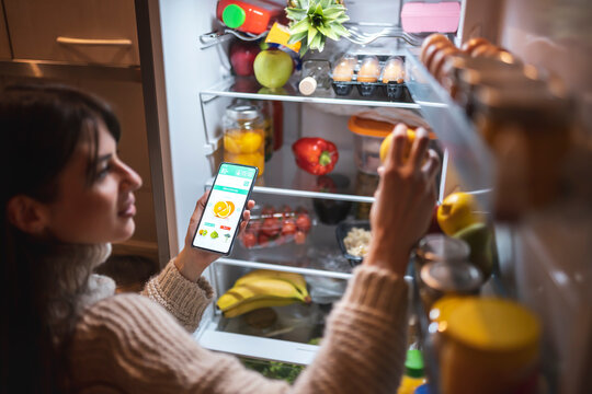 Woman ordering fruit and vegetables using a smart phone app