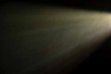 
flare of light on a black background. abstract spotlight background