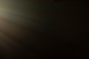 
flare of light on a black background. abstract spotlight background
