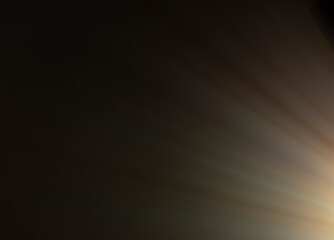 
flare of light on a black background. abstract spotlight background