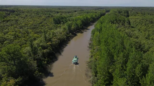 Aerial birds eye shot boat in river during sunny day