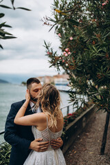 A romantic walk for the bride and groom along the shores of an Italian lake. It's a nasty day.