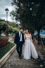 The bride and groom travel through the old Italian city.