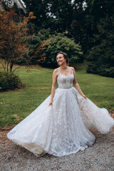 The bride is having fun in the park on a summer day.