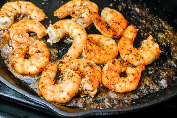Shrimp buttered in a cast iron skillet