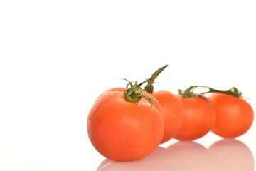 Several ripe, bright red, organic, tasty cocktail tomatoes, close-up, on a white background.
