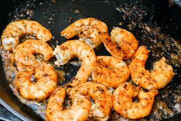 Shrimp buttered in a cast iron skillet