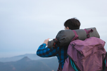 young man with backpack in the mountain