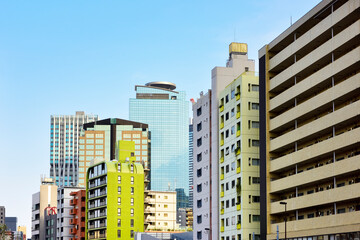 Fototapeta na wymiar Buildings and blue sky, Tokyo, Japan.　ビル街と青空 