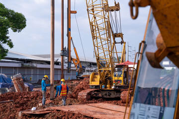 Construction worker Concrete pouring during commercial concreting floors of building in construction site and Civil Engineer or Construction engineer inspec work for drilling piles underground