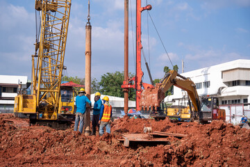 Team work construction worker Concrete pouring during commercial concreting floors of building in...