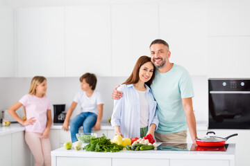 Portrait of big cheerful family handsome guy hug charming lady toothy smile look camera have good mood indoors