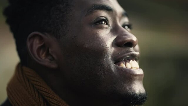Hopeful black African man close-up face joyful emotion