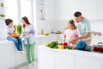 Photo portrait of parents spending weekend morning together with their children cooking meal washing dishes on white kitchen