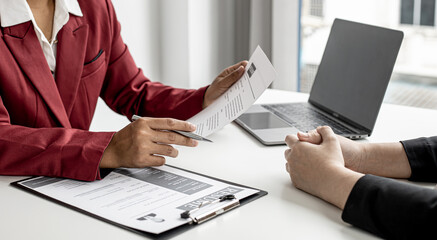 The manager is interviewing job applicants and reading the candidate's personal information on the...