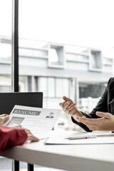 The job applicant is attending a job interview with the department manager and is introducing himself and explaining the information in the resume to the manager in order to be elected to the company.
