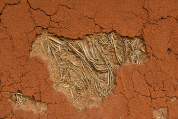 Damage wall surface of  Earthen House  that  shown  straw  inside .