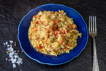 Risotto with chicken and vegetables. A plate of rice with vegetables. Selective focus.
