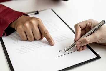 Naklejka premium The tenant is signing a lease agreement with the landlord after viewing the home and discussing the rental agreement details. Real estate rental ideas.