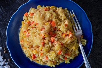 Risotto with chicken and vegetables. A plate of rice with vegetables. Selective focus.
