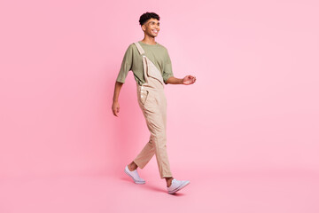 Profile photo of guy go look empty space beaming smile wear beige overall footwear isolated pink color background