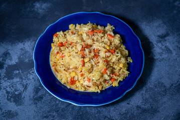 Risotto with chicken and vegetables. A plate of rice with vegetables. Selective focus.