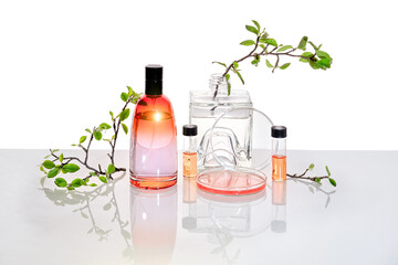Natural Green laboratory. Abstract floral design. Orange liquid product, fragrance, perfume in...