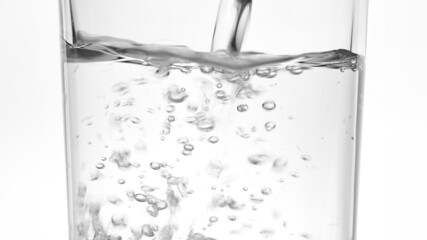 pouring water into a glass on white background