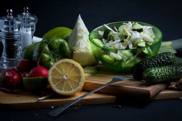 Fresh salad with cucumbers, cabbage, arugula and radish. salad ingredients and spices.