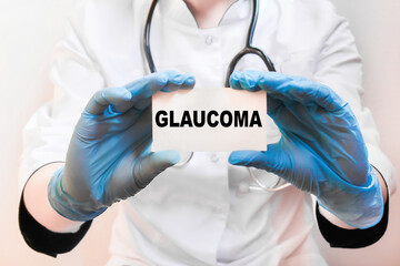 The doctor's blue - gloved hands show the word GLAUCOMA - . a gloved hand on a white background. Medical concept. the medicine