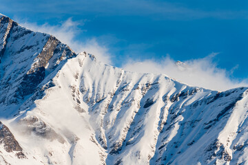 Fototapeta na wymiar Snow Covered Mountain Ridge with Clouds