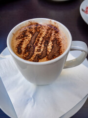 cup of cappuccino coffee with cocoa powder decoratingcup of cappuccino coffee with cocoa powder decorating