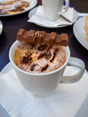 cup of cappuccino coffee with cocoa powder decoratingcup of cappuccino coffee with cocoa powder...