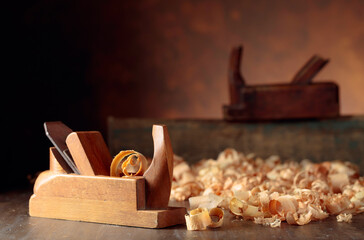 Old wooden jointers and shaving on wooden table.