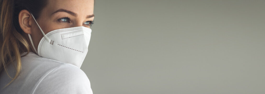 Young woman wearing  a facemask during coronavirus and flu outbreak. Virus and illness protection, home quarantine. COVID-19 concept - Powered by Adobe