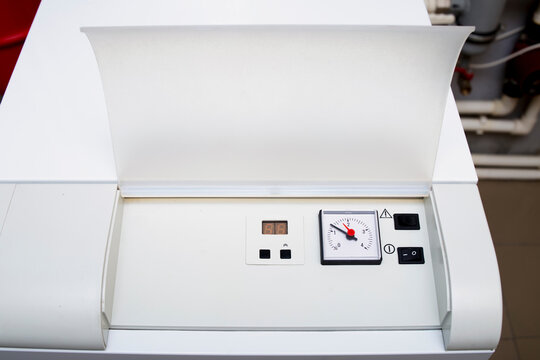 Gas boiler control panel, power button, temperature setting modes in the house. Boiler pressure monometer, temperature regulator.