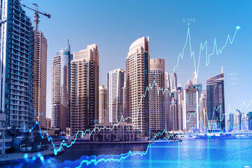 Skyscrapers of Dubai business downtown. International hub of trading and financial services of Western Asia. FOREX graph and chart concept. Double exposure. Dubai Canal waterfront.